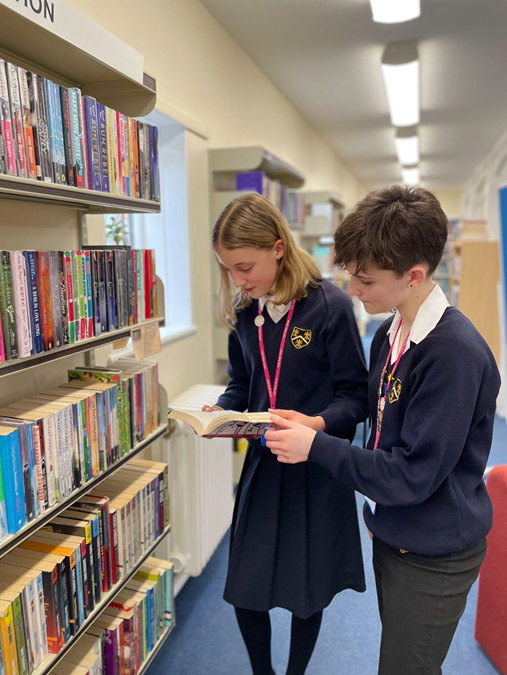 Photo of students browsing books in the school Library